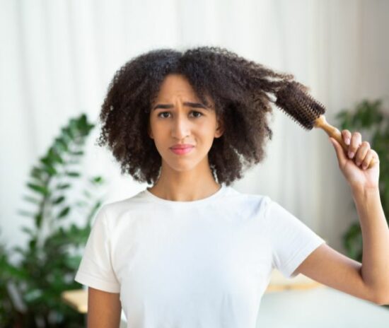 Curly woman combing-her hair