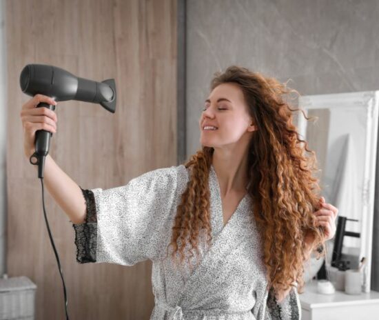 Girl using hair dryer